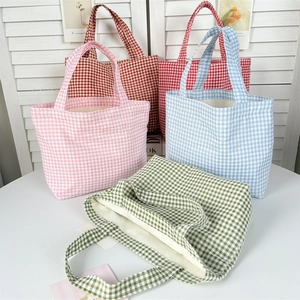 Detailed close-up of five colorful gingham canvas bags with thick texture and inner lining