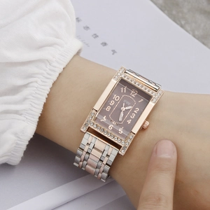 Elegant rectangular rose gold watch with rhinestone bezel and bicolor steel strap on wrist