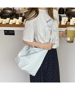 Detailed view of light blue canvas tote bag with Paris Bag Hello letter print