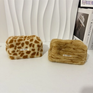Plush leopard and tiger print makeup bags with minimalist design and fuzzy texture