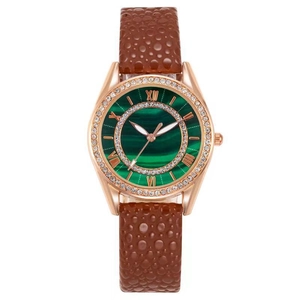 Close-up of green malachite dial with Roman numerals and diamond bezel on watch
