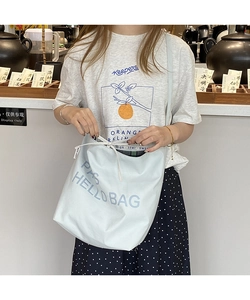 Detail view of light blue canvas tote bag with PAS HELLO BAG print and drawstring closure