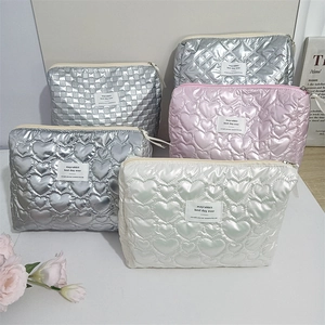 Close-up of quilted heart pattern and metallic finish on a stylish PU makeup bag