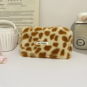 Plush leopard print makeup bag with a soft texture and spacious interior for cosmetics