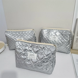 Silver quilted PU cosmetic bags in heart and diamond patterns with beige zippers