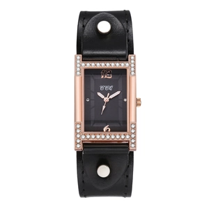 Detail of rose gold rectangular watch with rhinestone H-shaped lugs and black leather strap
