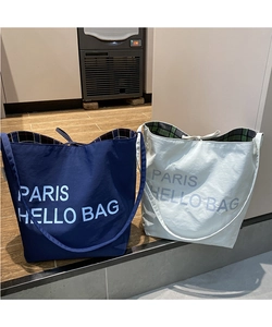 Detail of tote bag with Paris Hello Bag print and vintage plaid lining interior