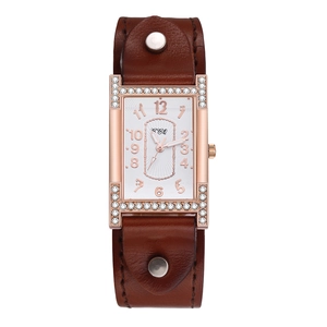 Close-up of rose gold H-shaped watch case with crystals and brown leather strap