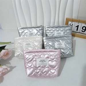 Close-up of quilted PU leather makeup bags with heart patterns and zipper details