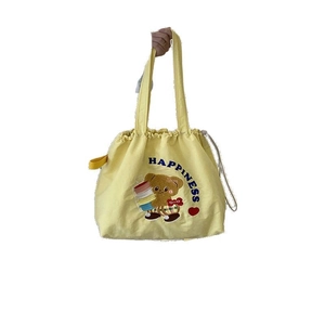 Yellow canvas tote bag with cartoon bear and drawstring closure for daily commuting