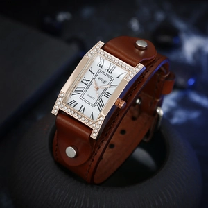 Macro view of vintage H-shaped crystal watch case with Roman numeral dial and rivets