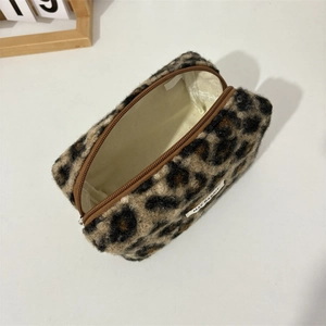 Detail view of leopard print plush makeup bag with textured fabric and zipper closure