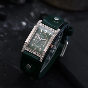 Detail of vintage square watch with crystal-encrusted gold case and green leather strap