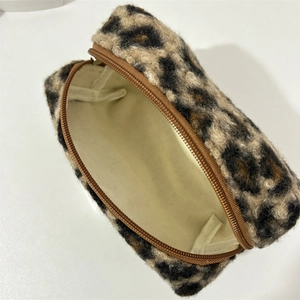 Detail of plush leopard print makeup bag with large capacity and smooth zipper closure
