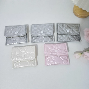 Top view of multiple quilted PU leather mini pouches in metallic and pearl finishes