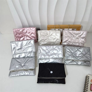 Close-up of quilted cosmetic coin purses with heart and star patterns in metallic colors