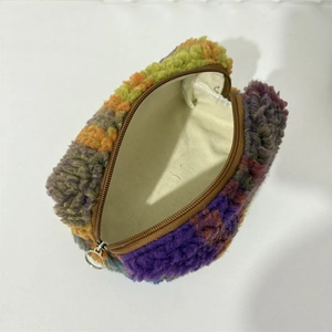 Macro view of multi-color plush makeup bag with smooth lining and durable zipper