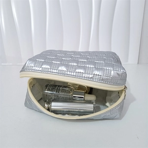 Close-up of silver quilted PU waterproof makeup bag showing spacious interior storage