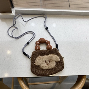 Detail of soft brown plush puppy bag featuring a woven adjustable shoulder strap