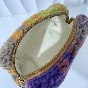 Detail view of plush makeup bag with colorful fleece exterior and durable canvas lining