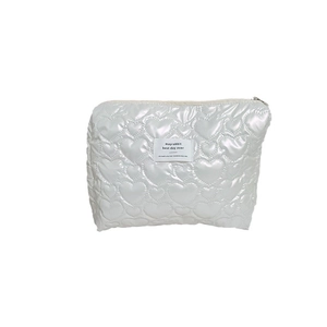 Chic silver quilted PU clutch bag featuring heart patterns and secure zipper closure