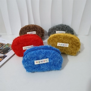 Dettaglio di mini borse a conchiglia in peluche colorato con morbida ecopelliccia e zip