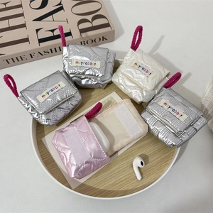 Quilted mini earphone pouches in silver, white, and pink with vibrant brand labels