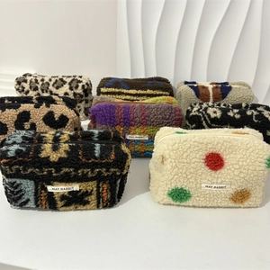 Plush makeup bags in leopard and checkered patterns with May Rabbit label