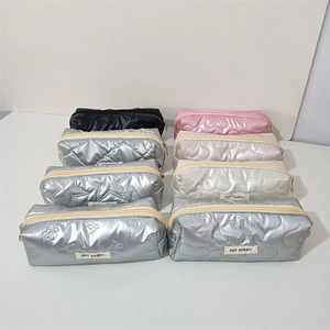 Detailed grid of quilted cosmetic bags with heart and star patterns in metallic finishes