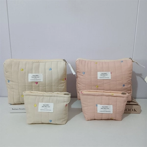 Quilted heart embroidery makeup bags in cream and pink colors with multiple sizes