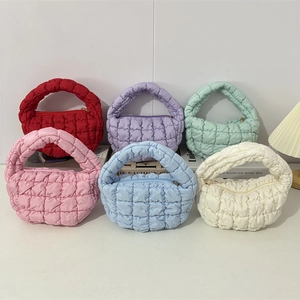 Detail view of colorful quilted puffer cloud bags with stylish square stitch patterns
