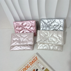 Quilted heart-pattern clutch bags in shiny metallic colors with snap button closure
