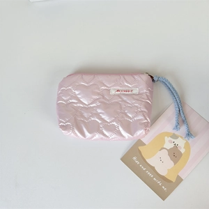 Detail of pink heart-quilted PU coin purse showing woven zipper pull and brand tag