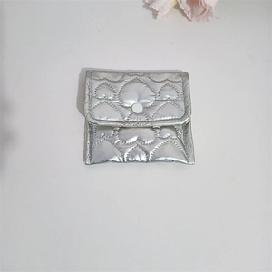 Detail of silver quilted heart pattern on PU leather coin purse with snap button closure