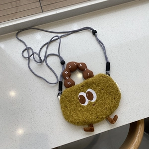 Detail of creative potato plush bag with large cartoon eyes and woven rope strap