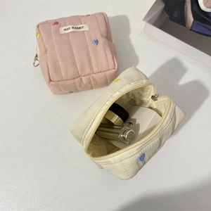 Quilted makeup bag with colorful heart embroidery and secure zipper closure for women