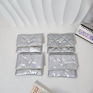 Detailed macro view of silver quilted pouches featuring heart and star patterns