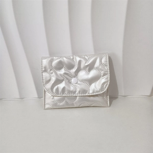 Close-up of white heart-quilted PU leather coin purse with a snap-button closure