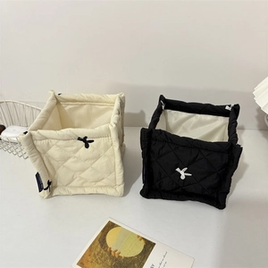 Detail of quilted storage baskets with rabbit embroidery and HEY RABBIT woven labels