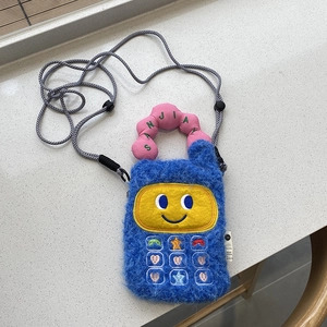 Detail of blue plush phone-shaped crossbody bag with embroidered colorful keypads