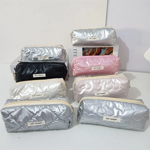 Multiple colorful quilted cosmetic bags and pencil cases with metallic star textures