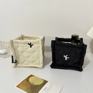Quilted bow storage baskets in cream and black for stylish home organization