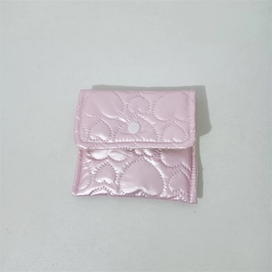 Pink heart quilted silk purse detail showing the snap closure and pearl-like texture