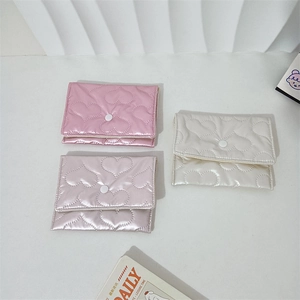 Three quilted heart pouches in pink and cream with satin finish and snap closure