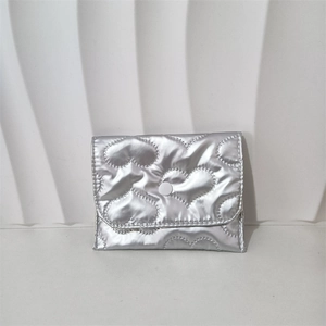 Close-up of silver PU coin purse with heart quilted texture and snap button closure