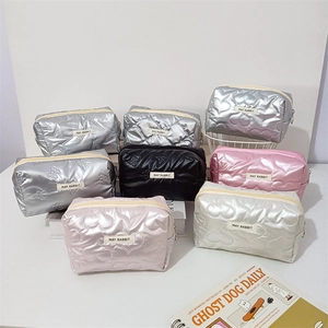 Close-up of quilted PU makeup bags with heart and star patterns and metal zippers