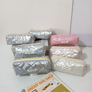 Quilted metallic pencil cases with heart and star patterns and brand labels