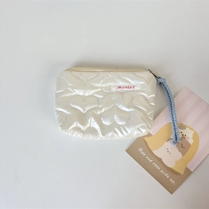 Close-up of quilted PU heart pattern coin purse with blue braided wrist strap and zip