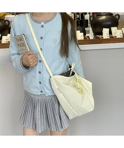 Detailed shot of cream white canvas tote bag with lucky home label and lettering