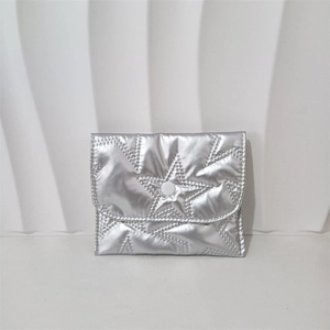 Close-up of metallic silver PU coin purse with star quilted pattern and snap closure